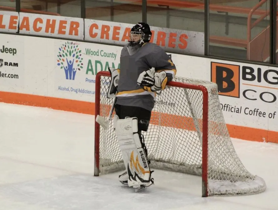 A hockey goalie guarding the net.